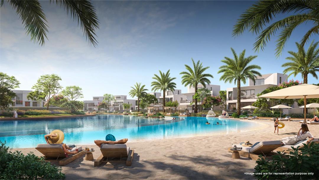 Children enjoying the kiddie pool at Emaar Palmiera At The Oasis, surrounded by lush greenery and family-friendly amenities